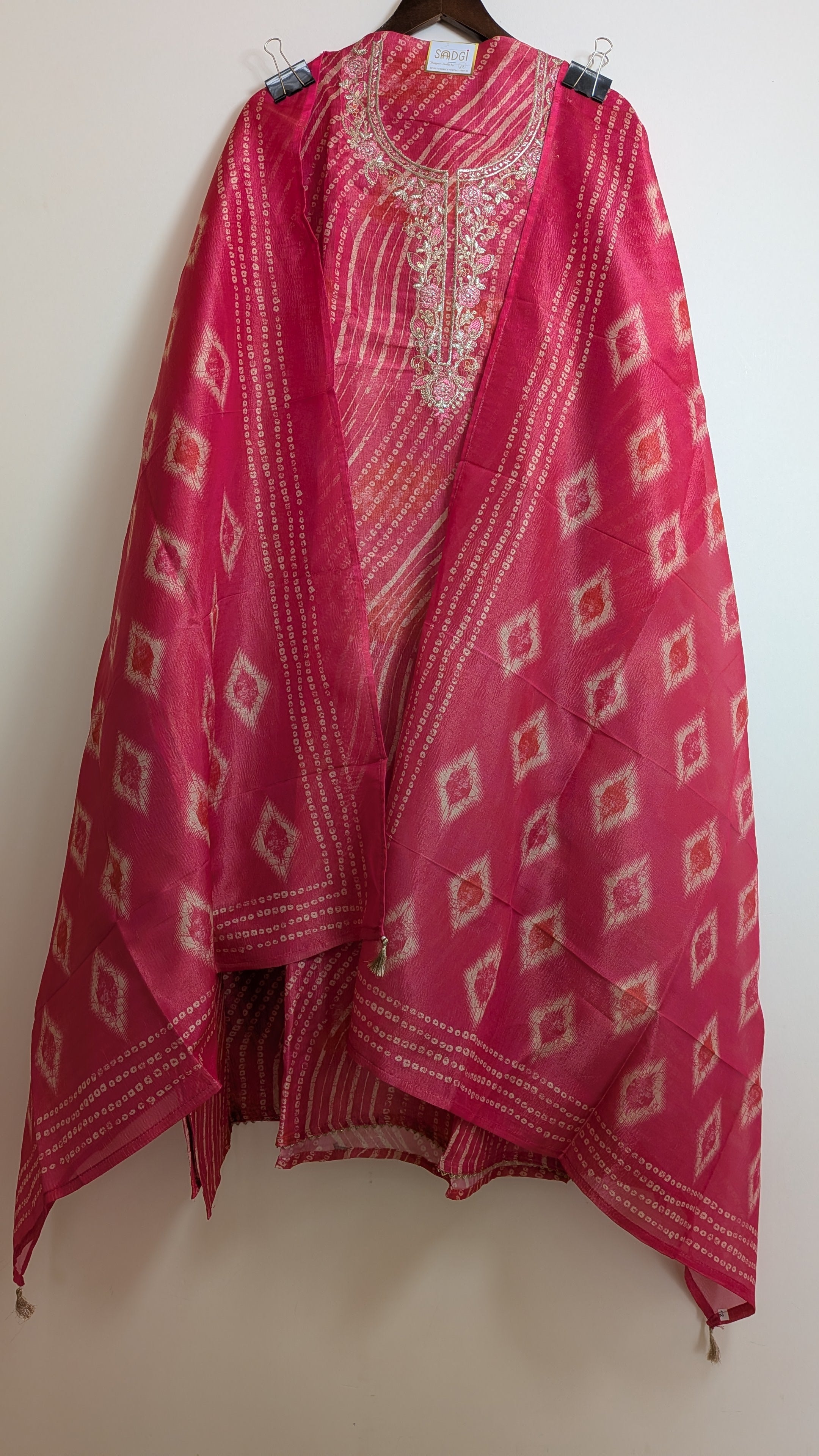 Pink traditional outfit with white patterns on a white background