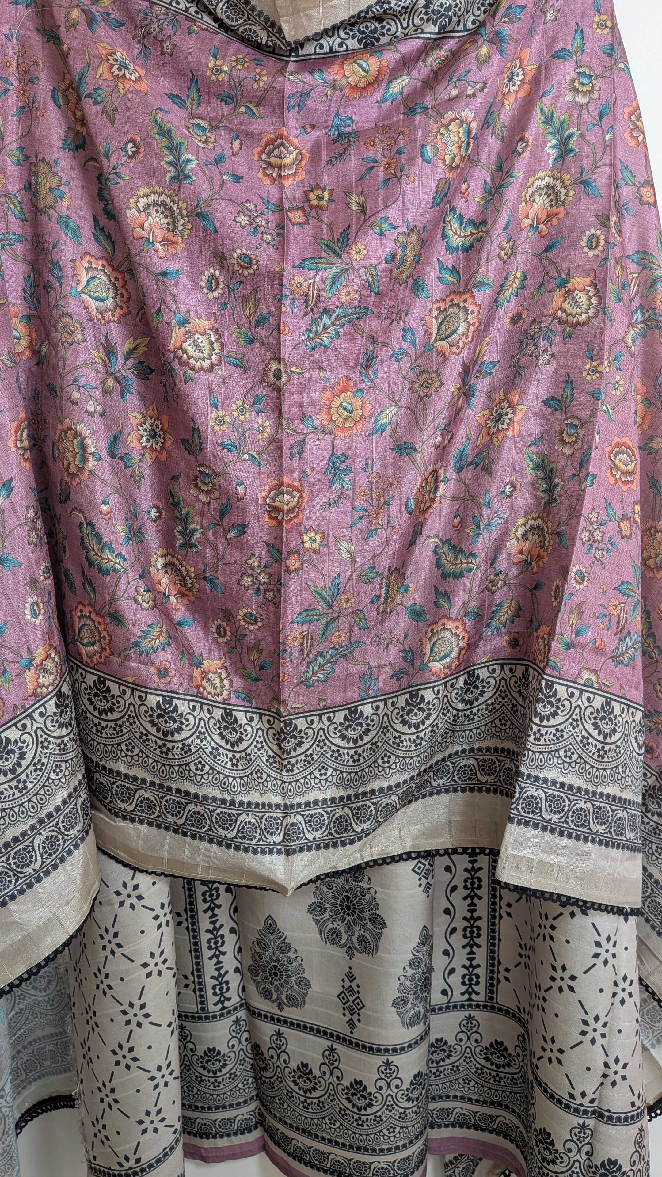 Traditional pink and black patterned fabric with floral designs