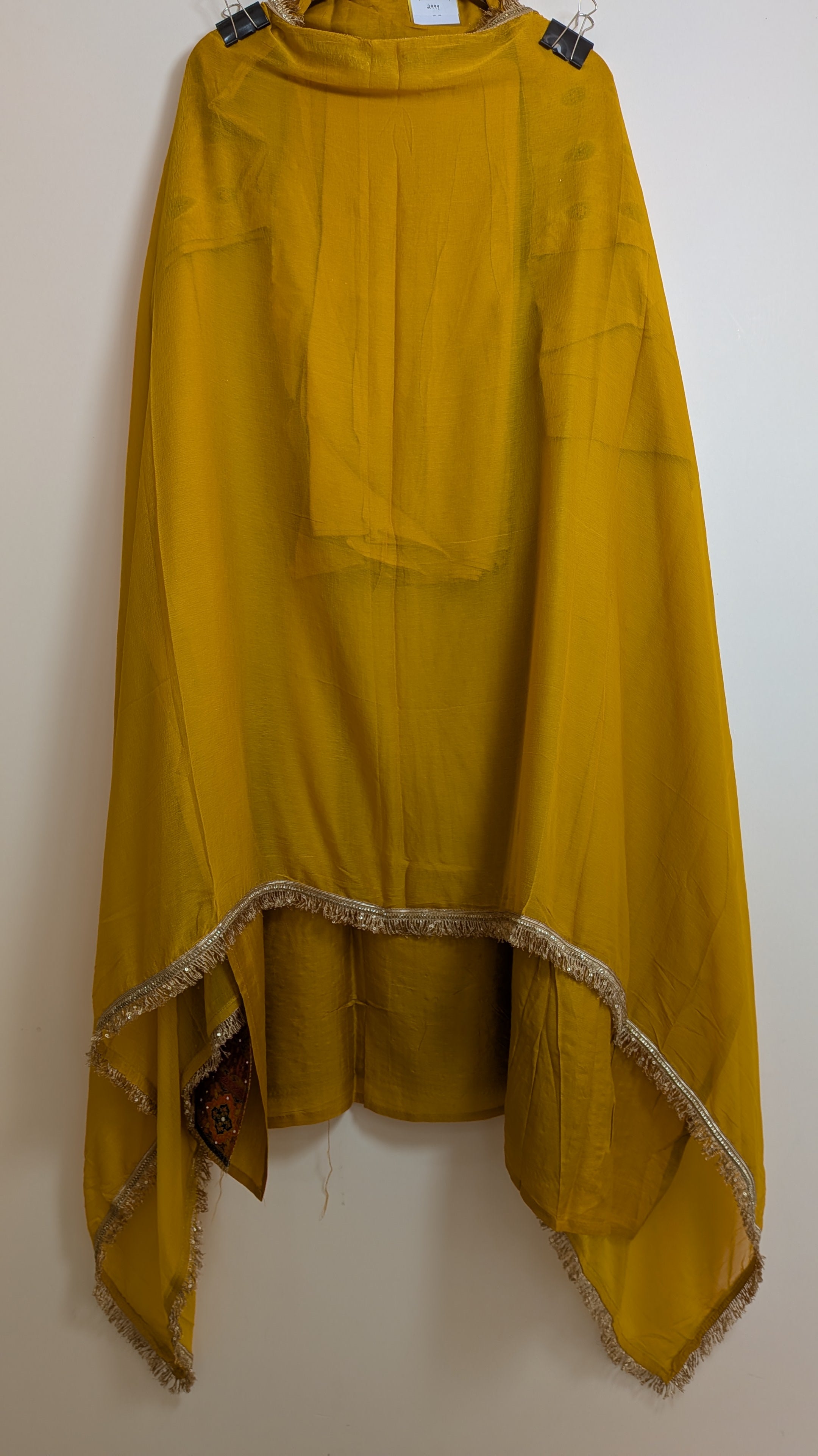 Mustard yellow poncho with a textured trim on a white background