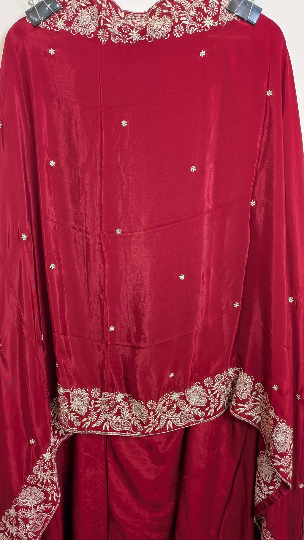 Red traditional outfit with gold embroidery on a white background