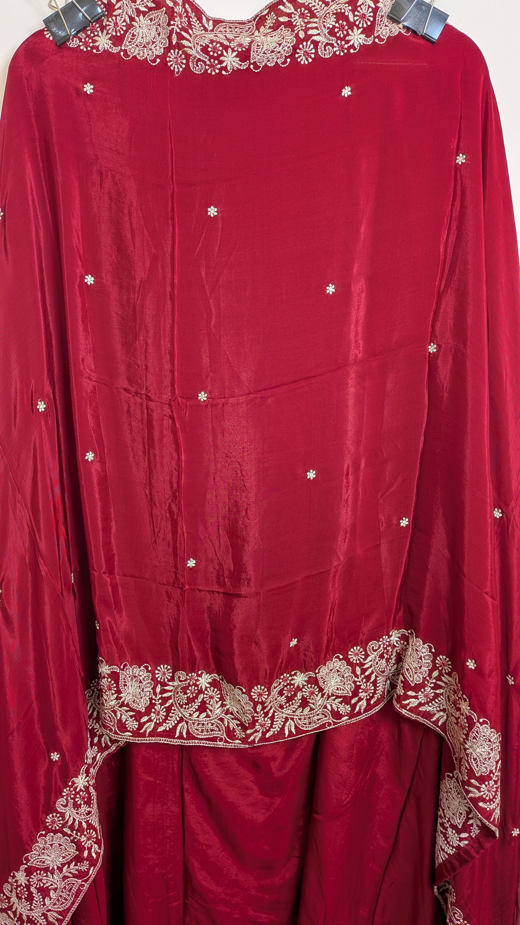 Red traditional outfit with gold embroidery on a white background