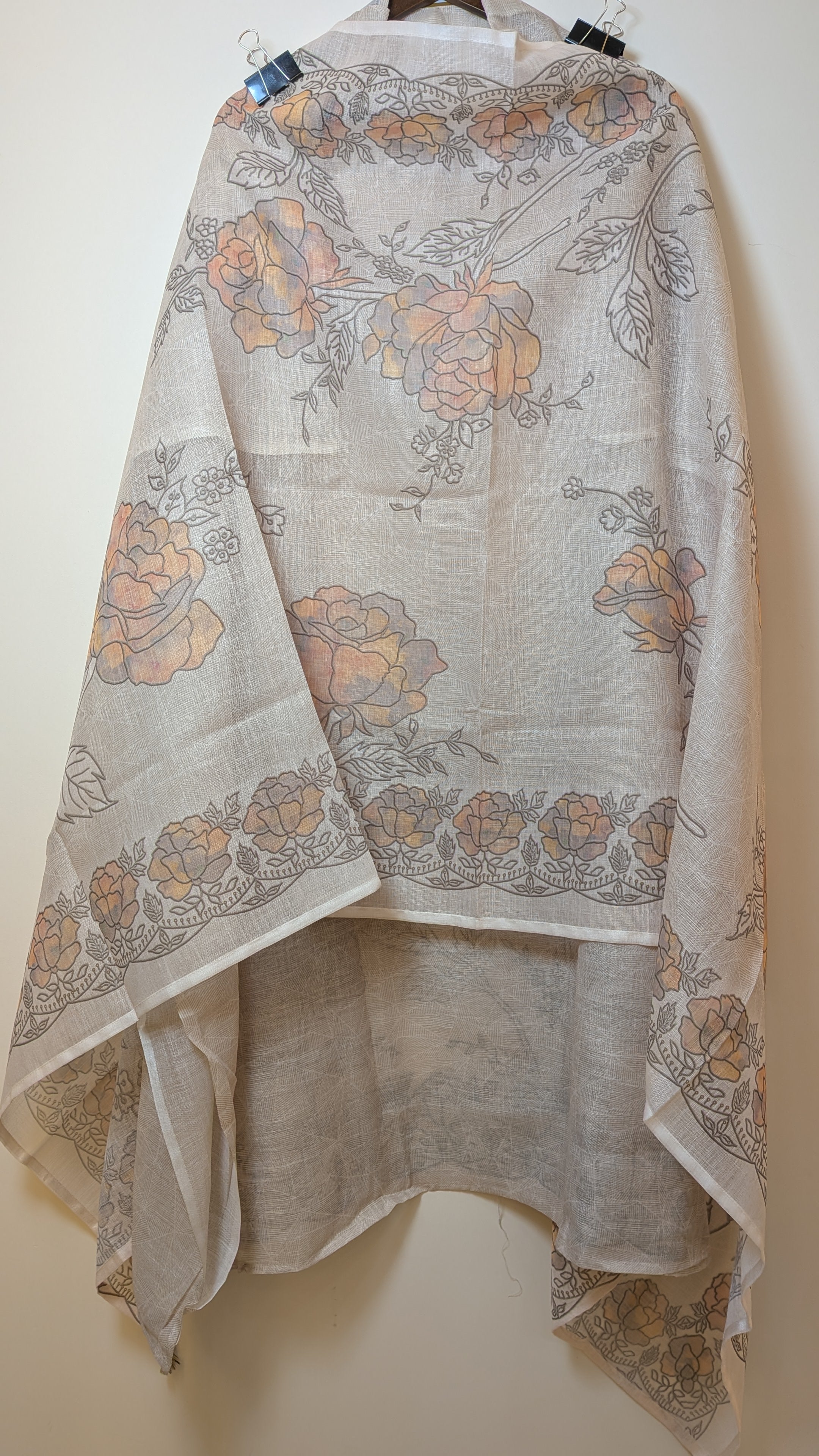 Floral patterned scarf draped over a white surface