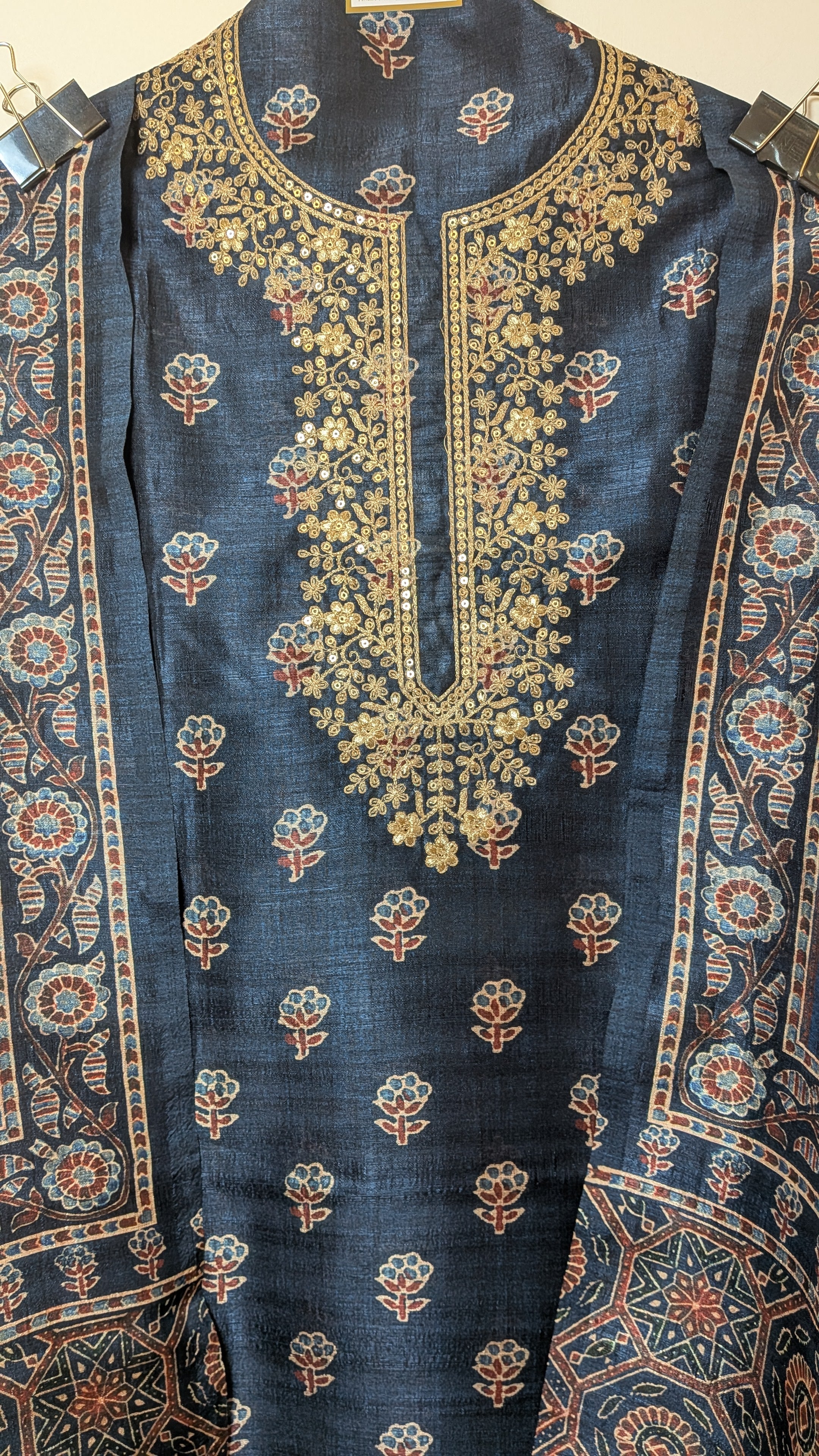 Embroidered fabric with intricate patterns on a dark blue background