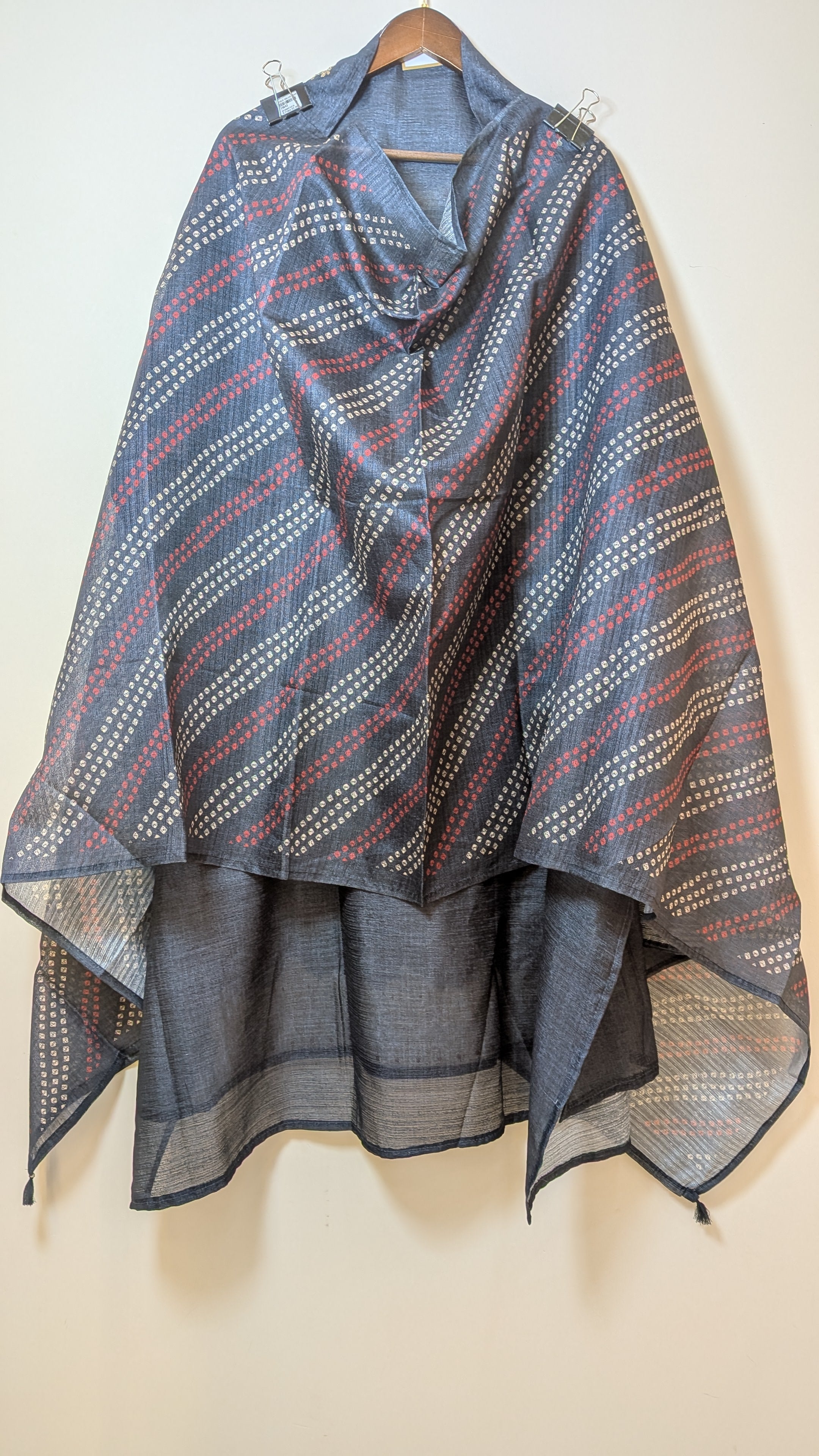 Textured scarf with geometric pattern on a beige background